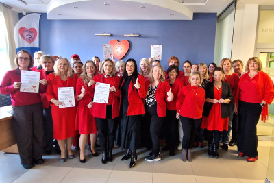 Dyrekcja i pracownicy ubrani na czerwono na tle logo SPZZLO Warszawa Żoliborz-Bielany.